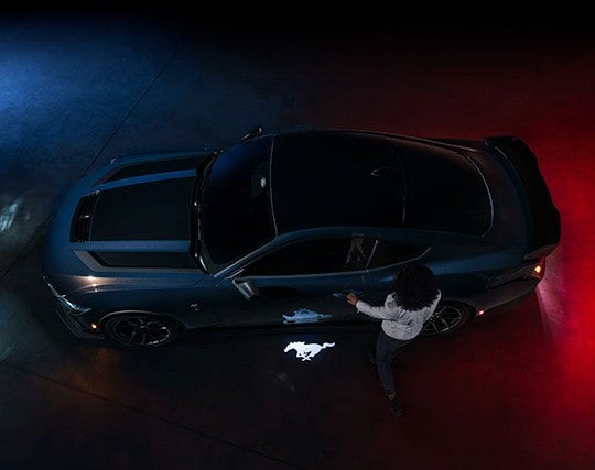 2024 Ford Mustang® Dark Horse™ model with a driver approaching the vehicle | Woody Ford in Madill OK