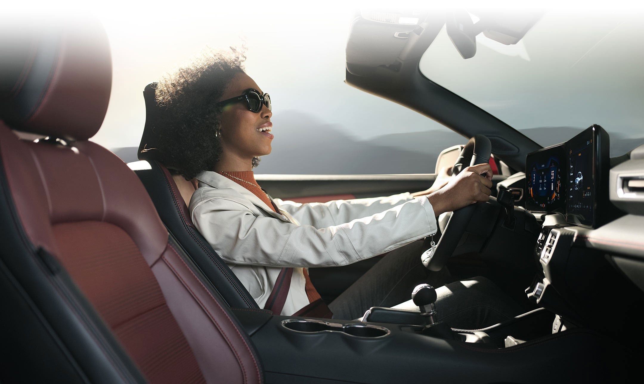 Person sitting in the driver’s seat of a 2024 Ford Mustang® convertible | Woody Ford in Madill OK